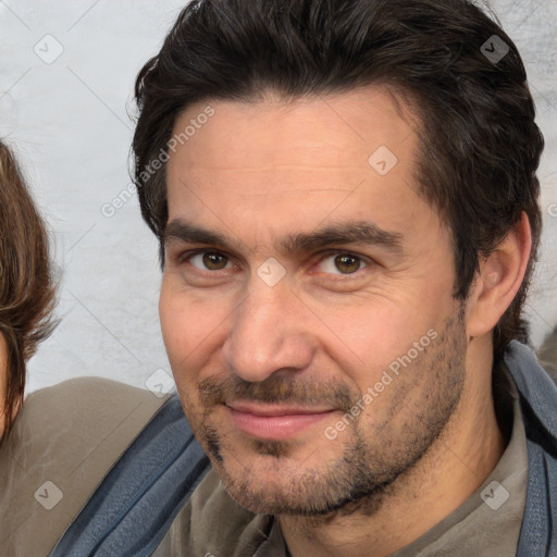 Joyful white adult male with short  brown hair and brown eyes