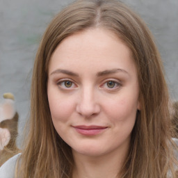 Joyful white young-adult female with long  brown hair and green eyes