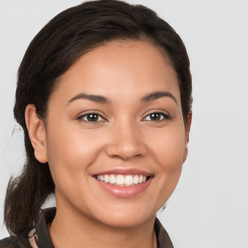 Joyful white young-adult female with long  brown hair and brown eyes