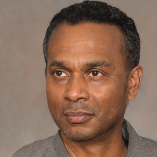 Neutral black adult male with short  black hair and brown eyes