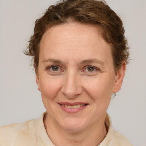 Joyful white adult female with short  brown hair and brown eyes