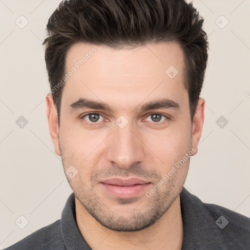 Joyful white young-adult male with short  brown hair and brown eyes