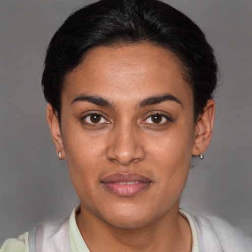 Joyful latino young-adult female with short  black hair and brown eyes