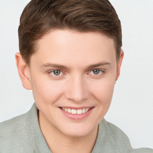 Joyful white young-adult female with short  brown hair and grey eyes