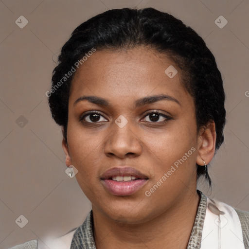 Joyful black young-adult female with short  black hair and brown eyes