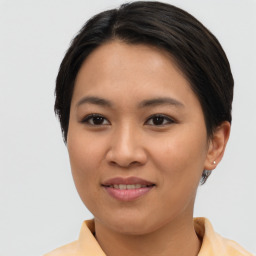 Joyful asian young-adult female with short  brown hair and brown eyes