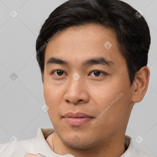 Joyful asian young-adult male with short  brown hair and brown eyes