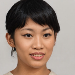 Joyful asian young-adult female with short  brown hair and brown eyes