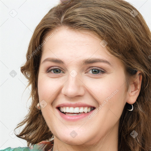 Joyful white young-adult female with long  brown hair and green eyes