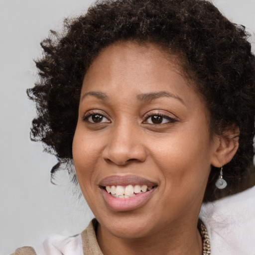 Joyful black young-adult female with medium  brown hair and brown eyes