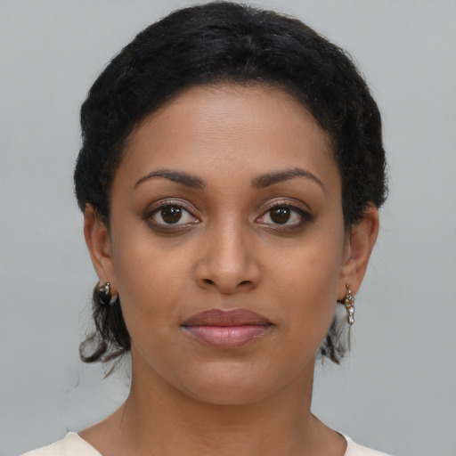 Joyful latino young-adult female with short  brown hair and brown eyes