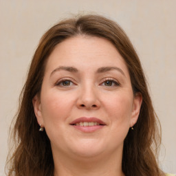 Joyful white adult female with long  brown hair and brown eyes