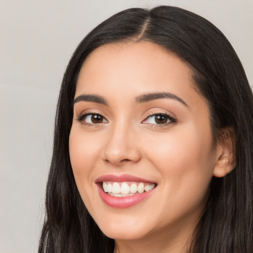 Joyful white young-adult female with long  black hair and brown eyes