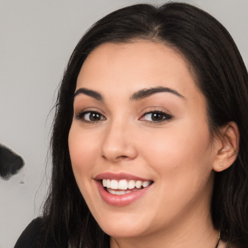 Joyful white young-adult female with long  black hair and brown eyes