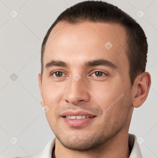 Joyful white young-adult male with short  brown hair and brown eyes