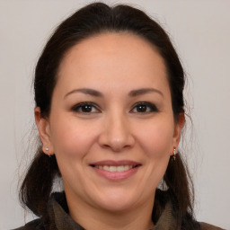 Joyful white adult female with medium  brown hair and brown eyes