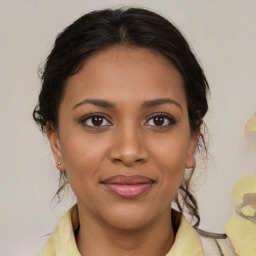 Joyful black young-adult female with medium  brown hair and brown eyes