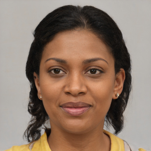 Joyful black young-adult female with medium  brown hair and brown eyes