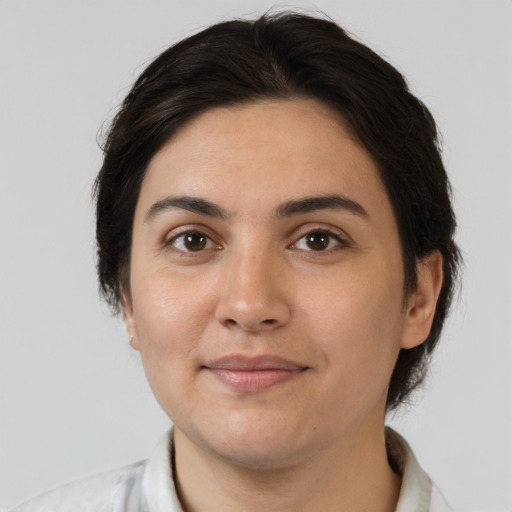 Joyful white young-adult female with medium  brown hair and brown eyes