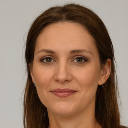 Joyful white adult female with long  brown hair and brown eyes