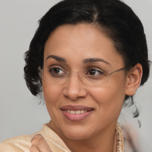 Joyful latino adult female with medium  brown hair and brown eyes