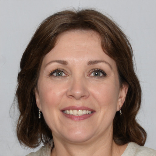 Joyful white adult female with medium  brown hair and brown eyes