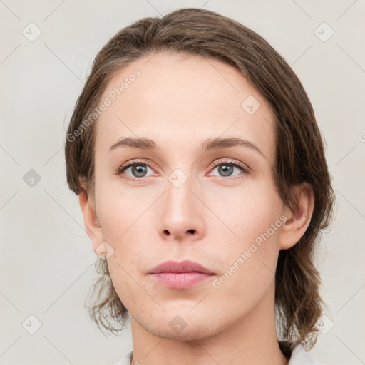 Neutral white young-adult female with medium  brown hair and green eyes