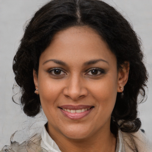 Joyful black young-adult female with medium  brown hair and brown eyes