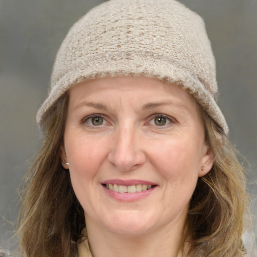 Joyful white adult female with medium  brown hair and grey eyes