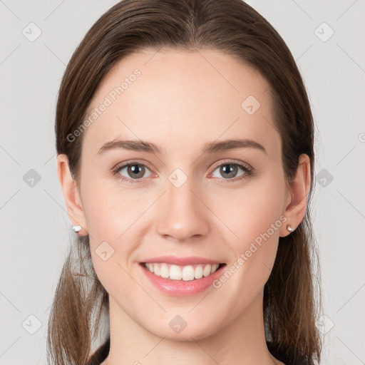 Joyful white young-adult female with long  brown hair and grey eyes