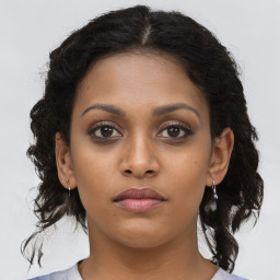 Neutral black young-adult female with medium  brown hair and brown eyes