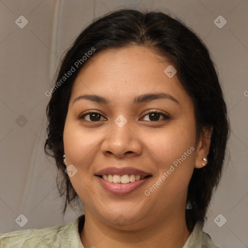 Joyful latino young-adult female with medium  brown hair and brown eyes