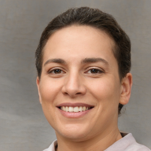 Joyful white young-adult female with short  brown hair and brown eyes