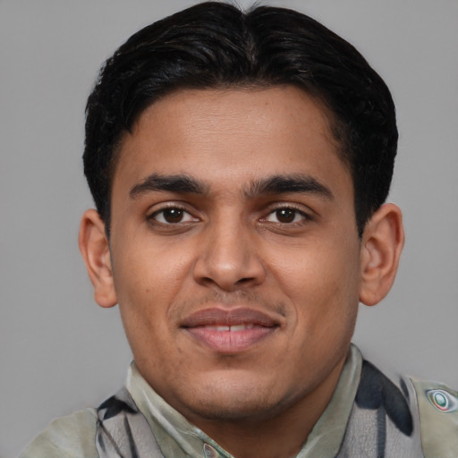 Joyful latino young-adult male with short  brown hair and brown eyes
