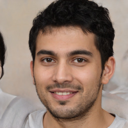 Joyful white young-adult male with short  black hair and brown eyes