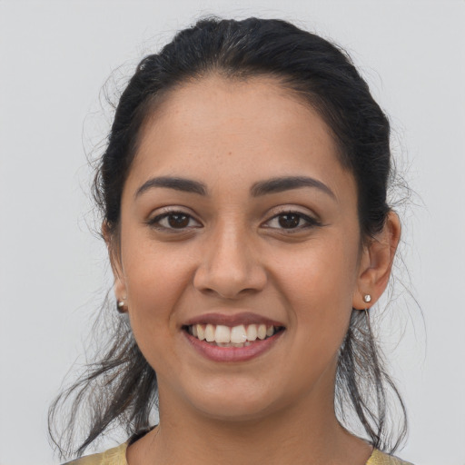 Joyful latino young-adult female with medium  brown hair and brown eyes