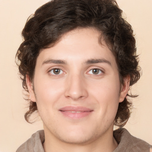 Joyful white young-adult male with medium  brown hair and brown eyes