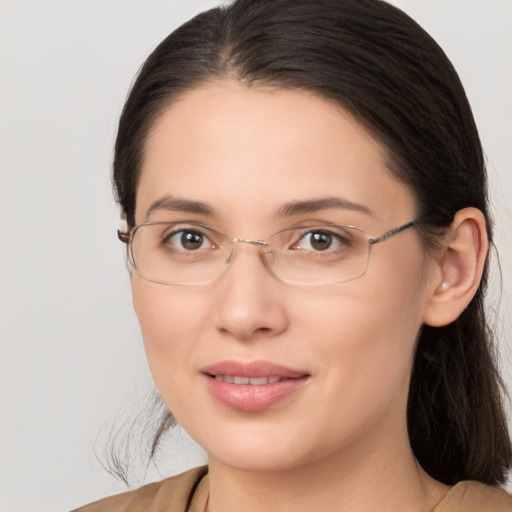 Joyful white young-adult female with medium  brown hair and grey eyes