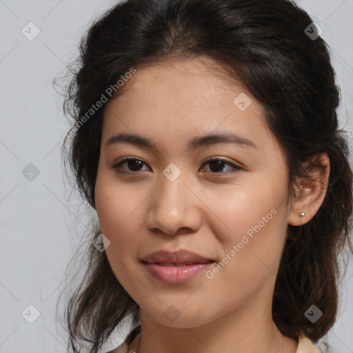 Joyful latino young-adult female with medium  brown hair and brown eyes