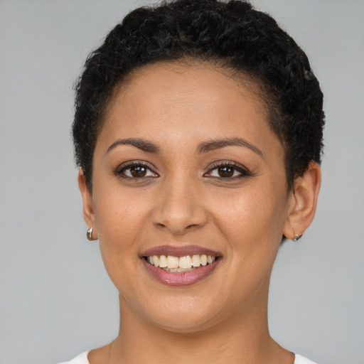 Joyful latino young-adult female with short  brown hair and brown eyes