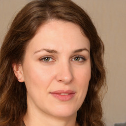 Joyful white young-adult female with long  brown hair and green eyes