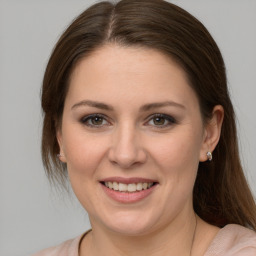 Joyful white young-adult female with medium  brown hair and grey eyes