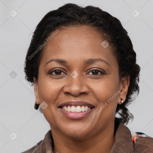 Joyful black adult female with medium  brown hair and brown eyes