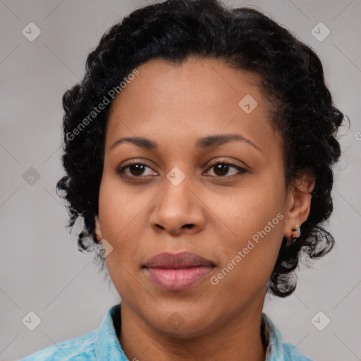 Joyful black adult female with medium  brown hair and brown eyes