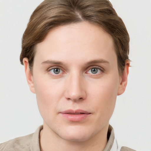 Joyful white young-adult female with short  brown hair and grey eyes