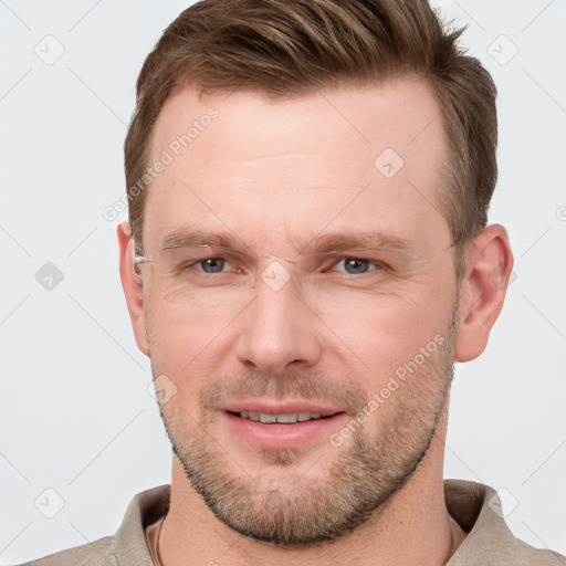 Joyful white adult male with short  brown hair and grey eyes