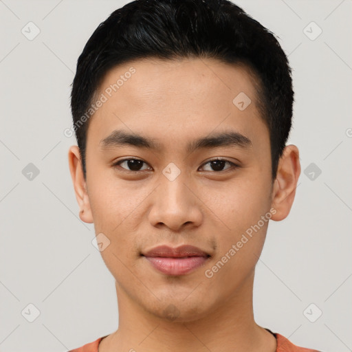 Joyful asian young-adult male with short  black hair and brown eyes