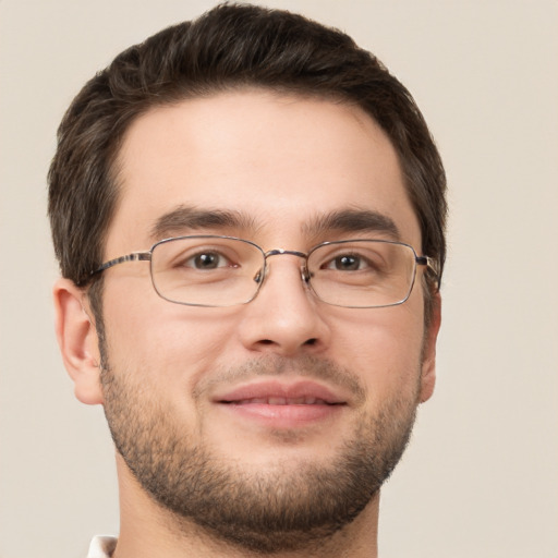 Joyful white young-adult male with short  brown hair and brown eyes