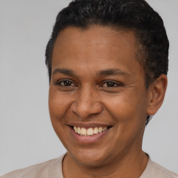 Joyful latino young-adult male with short  brown hair and brown eyes