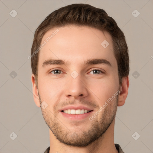 Joyful white young-adult male with short  brown hair and grey eyes